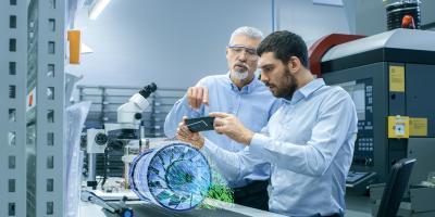 Analysis Simulation two men looking at simulation through mobile device in lab