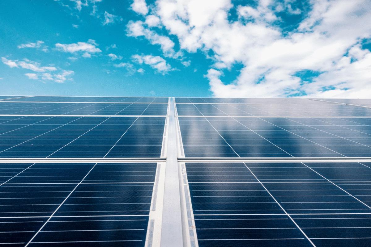 Blue sky and clouds reflected in solar panels