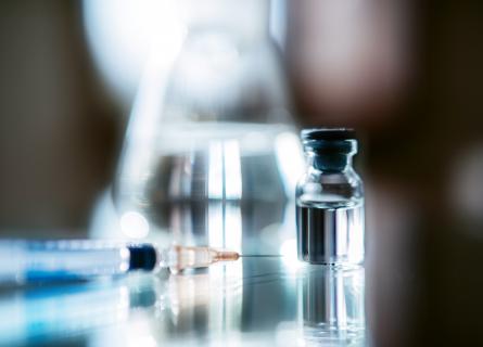 Medicine and syringe in a lab environment