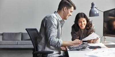 man and woman working together in office