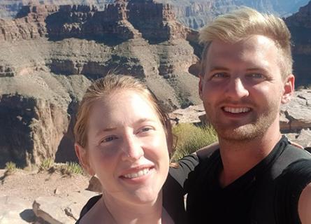 A selfie of a man and a woman on a mountain in California.