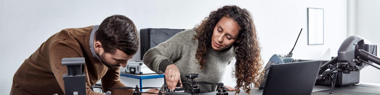 Woman and man looking at robotics