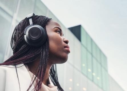 Woman wearing headphones with eyes directed up