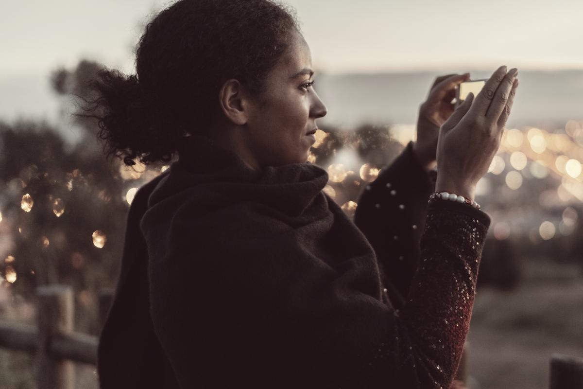 Woman taking picture of town