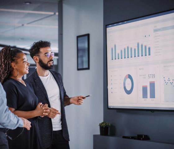 3 people looking at screen with dashboard.