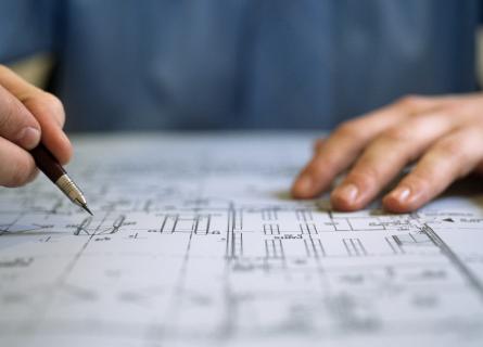 Close up of hands with pen and paper design plan