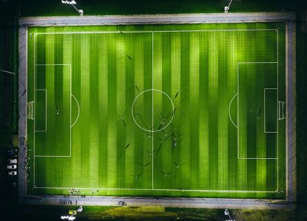 Football stadium lit at night.
