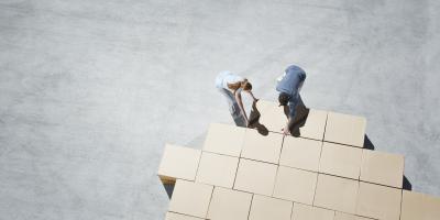 two people organize cardboard boxes logistics packaging