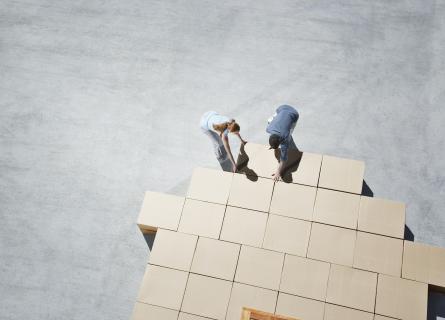 two people organize cardboard boxes logistics packaging