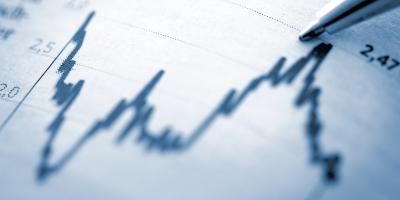 Data chart with pen pointing at peak
