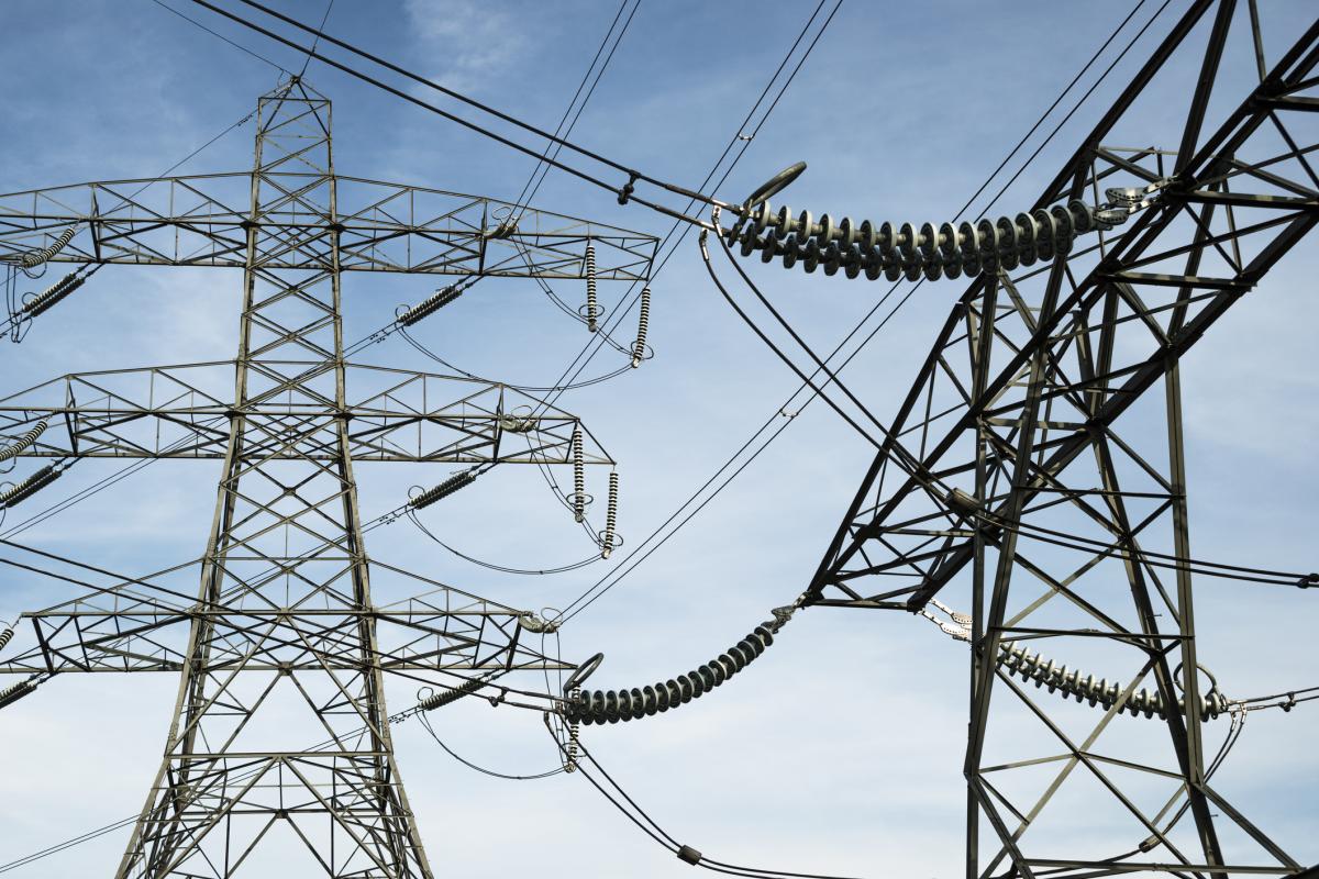 Electricity pylons against a blue sky