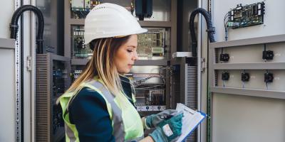 Woman in helmet working