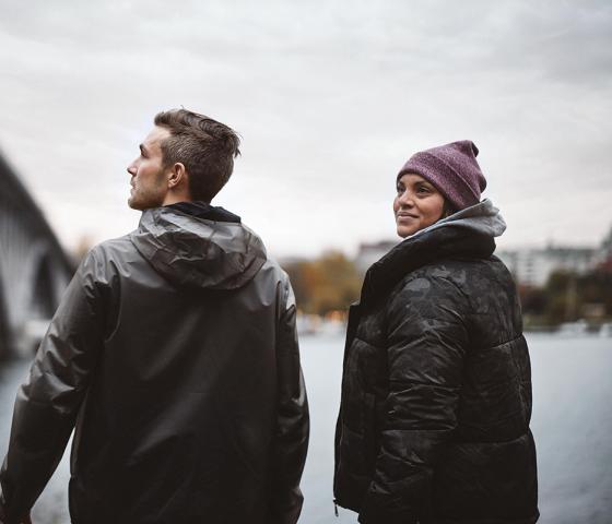 A man and a woman beside a bridge