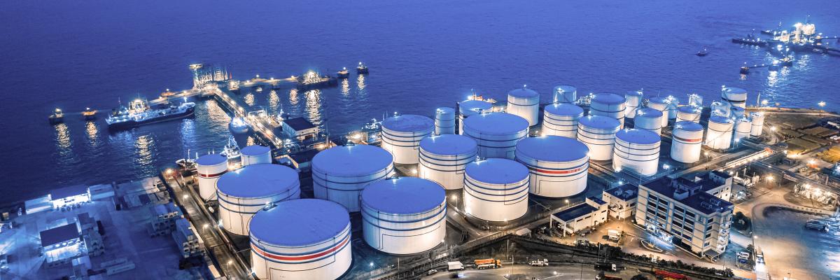 Onshore LNG storage tank facility in evening blue light