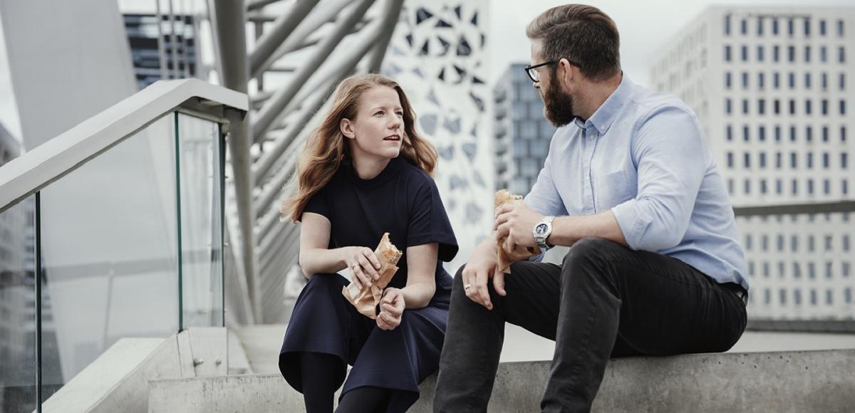 Two people are talking sitting in a staircase