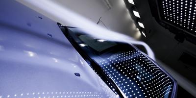 Close up of a white car in dark tunnel