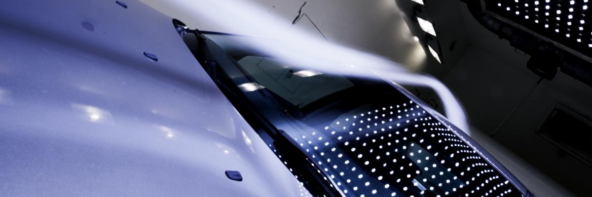 Close up of a white car in dark tunnel