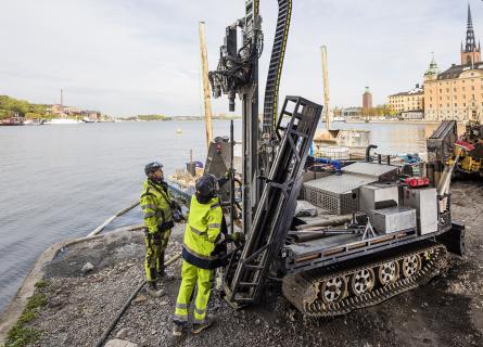 Ground investigations machinery and people in a city waterfront
