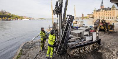 Ground investigations machinery and people in a city waterfront