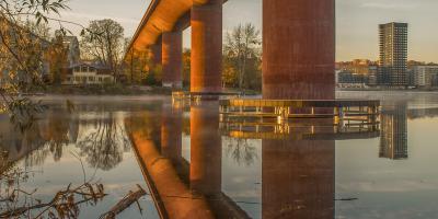 Reflection of a bridge on calm water