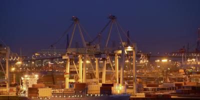 Ship in a harbour, containers and cranes at the background