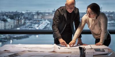 Woman and man looking over plans for life cycle assessment