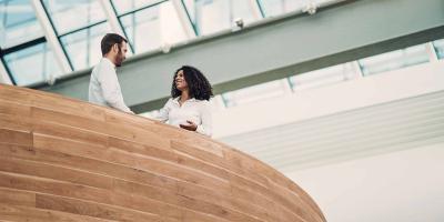  Bioeconomy experts shaking hands in cooperation behind wooden railing