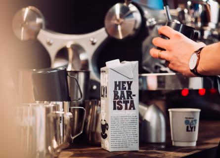 Package of Oatly oat drink in a café