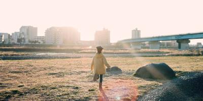 Girl running towards the sunlight in a preferred future vision