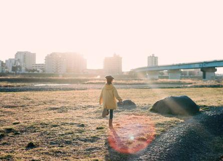 Girl running towards the sunlight in a preferred future vision