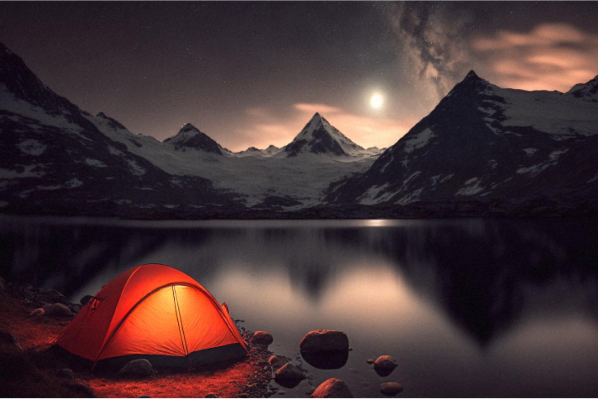 An orange tent next to a lake by high mountains 