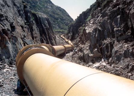 Yellow penstocks leading through an open installation trench