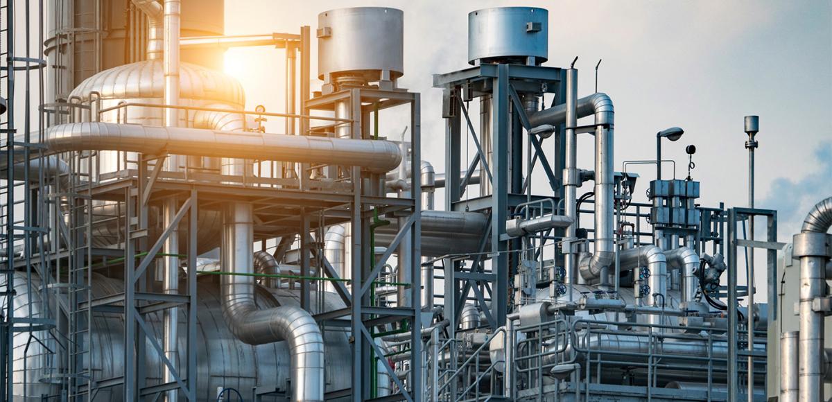 Industrial pipelines with sunset, hero image for process industries