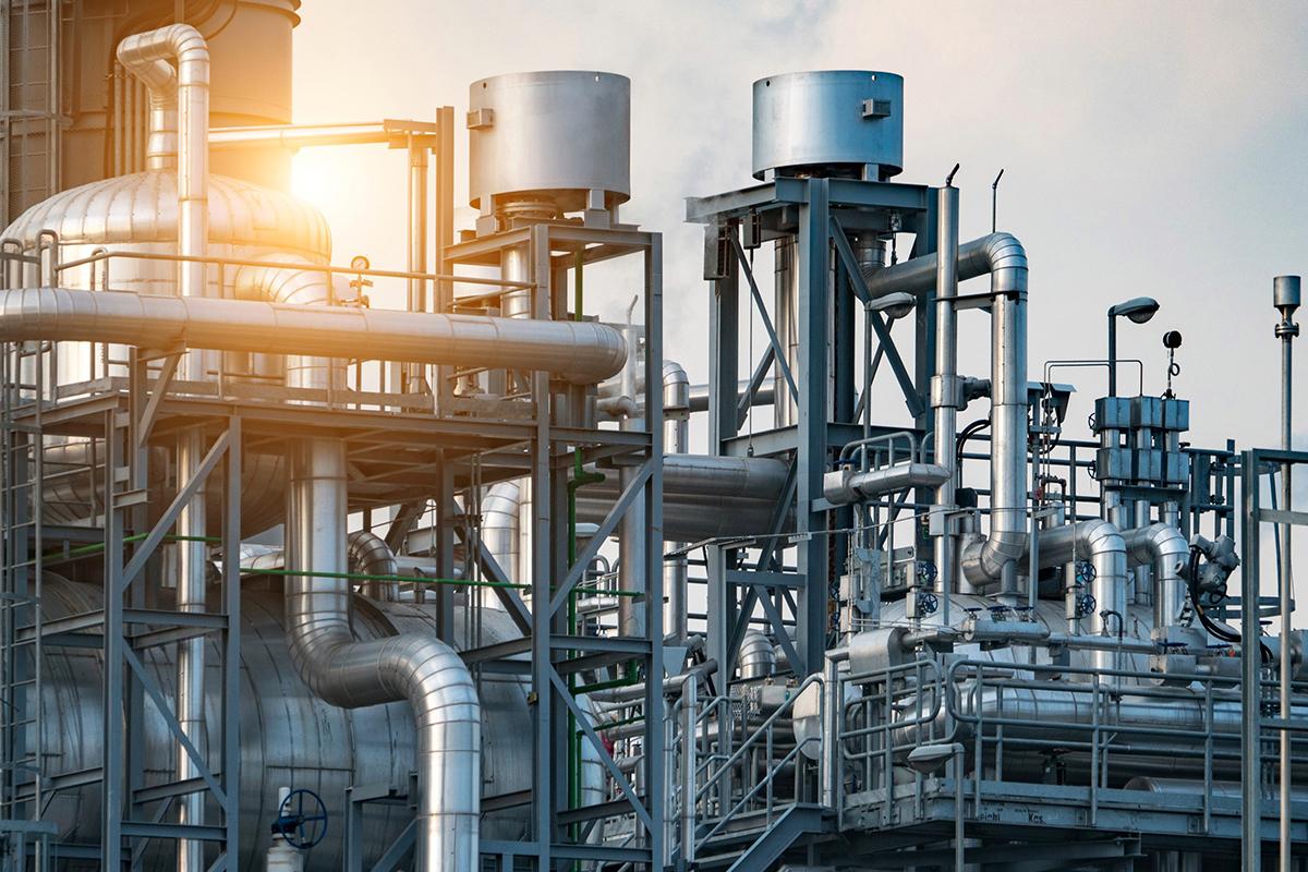 Industrial pipelines with sunset, hero image for process industries