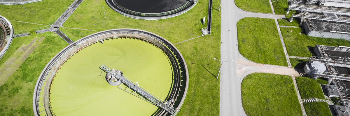 Sewage farm. Static aerial photo looking down onto the clarifying tanks and green grass.