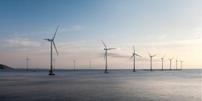offshore wind farm at dusk, renewable energy background