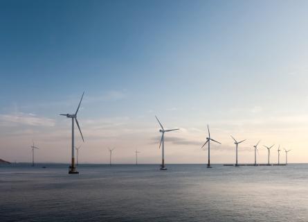 offshore wind farm at dusk, renewable energy background