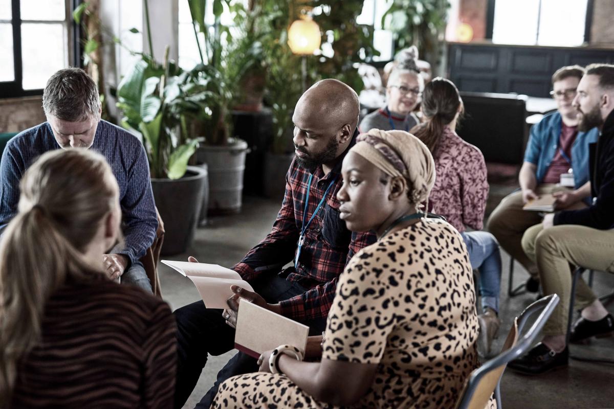 people sitting around in a circle listening and talking