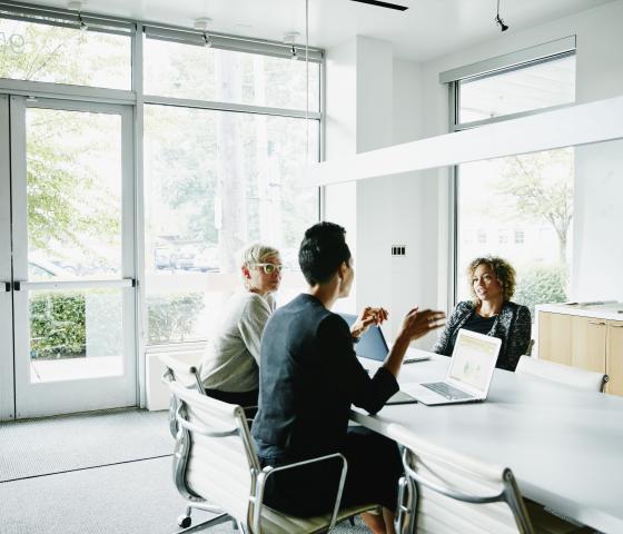 Women sitting around a table and having a meeting