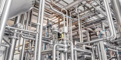 Stainless steel pipes in the factory. Construction on food production.