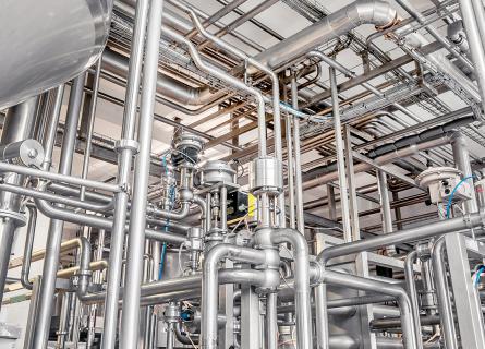 Stainless steel pipes in the factory. Construction on food production.
