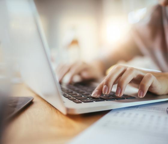 Woman typing on a laptop