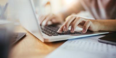 Woman typing on a laptop