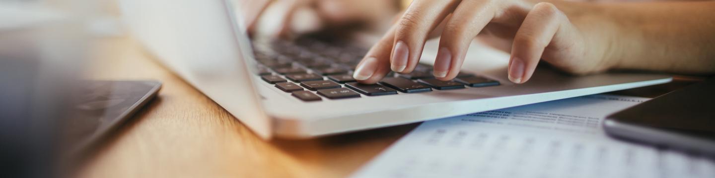 Woman typing on a laptop