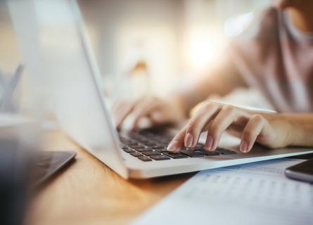 Woman typing on a laptop