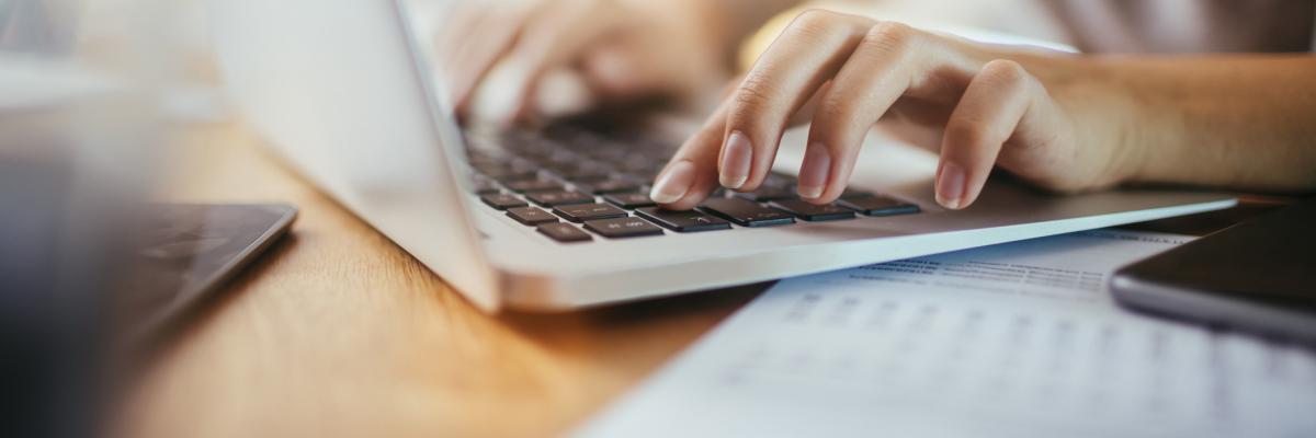 Woman typing on a laptop