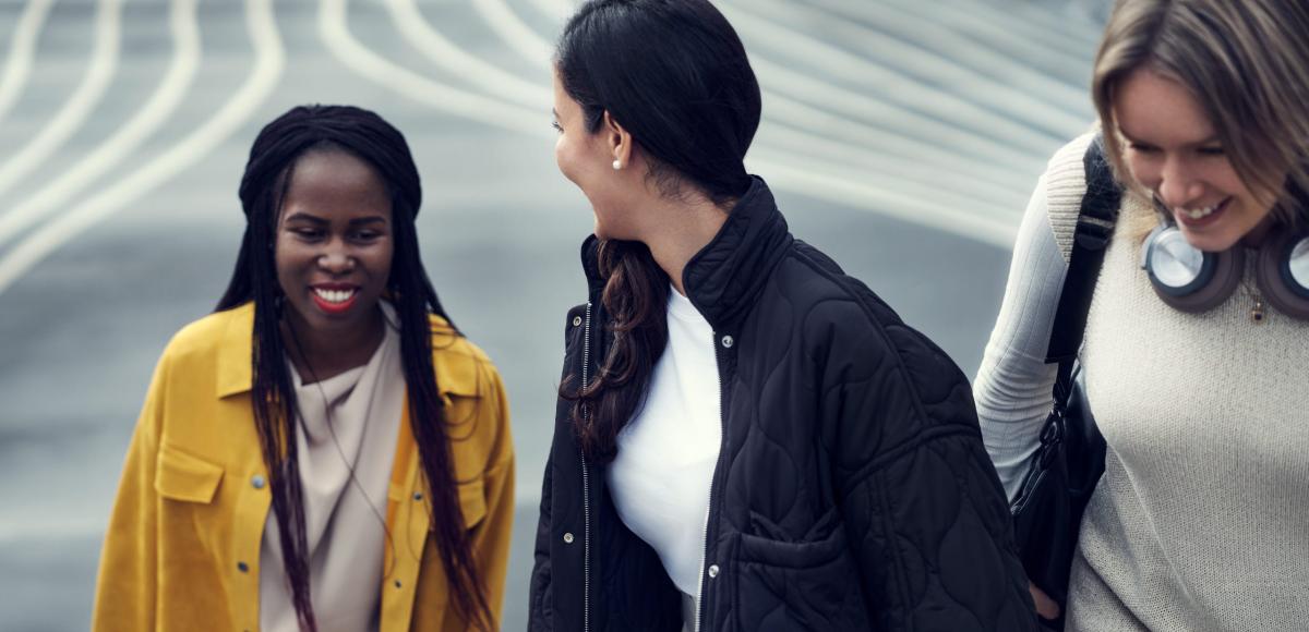 Young women walking together up steps