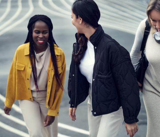 Young women walking together up steps